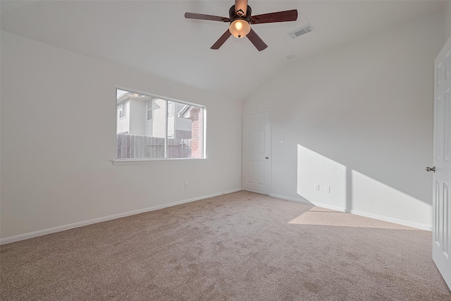 6723 Highwind Bend Ln, Katy, TX 77449 - empty room featuring light carpet, lofted ceiling, a ceiling fan, and baseboards