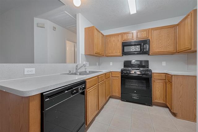 6723 Highwind Bend Ln, Katy, TX 77449 - kitchen with black appliances, a sink, light tile patterned flooring, a peninsula, and light countertops