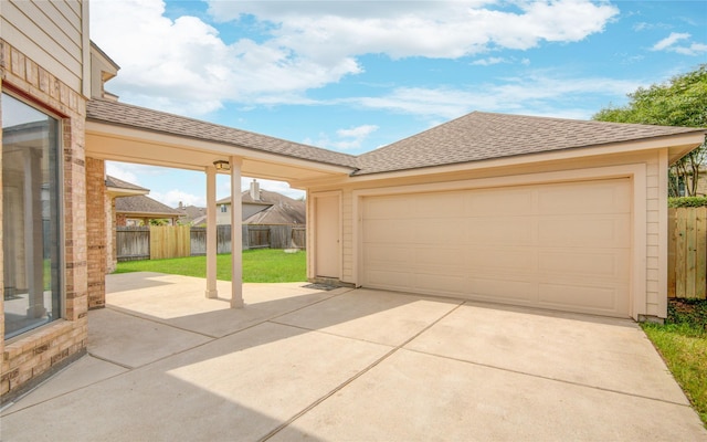 garage featuring concrete driveway