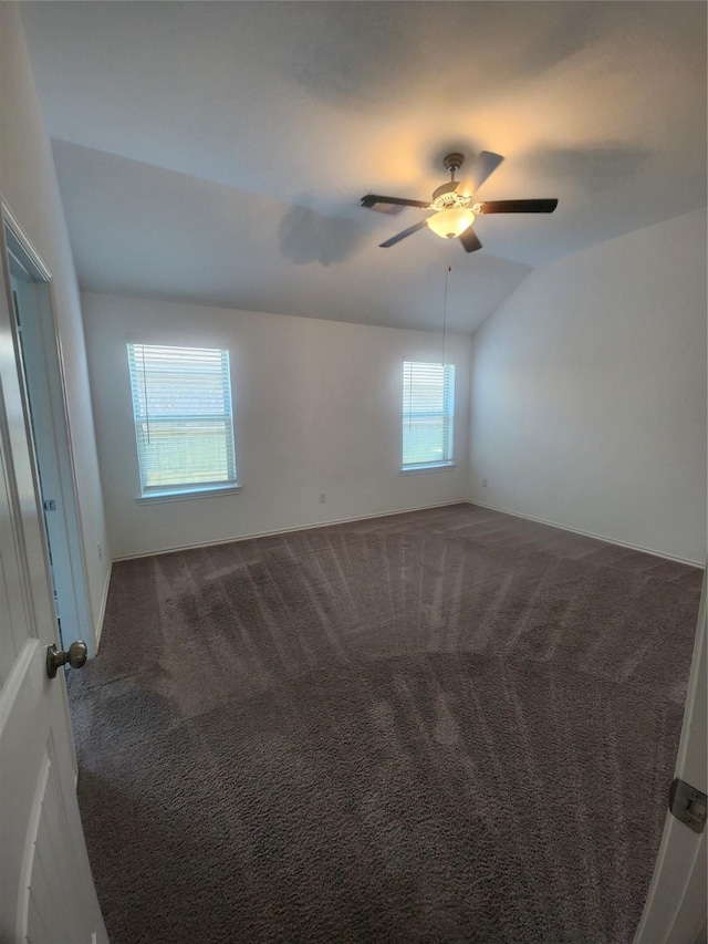 23716 Wood Green Terrace Dr, New Caney, TX 77357 - empty room with lofted ceiling, dark carpet, ceiling fan, and baseboards