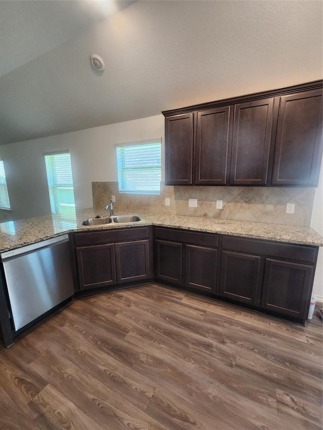 23716 Wood Green Terrace Dr, New Caney, TX 77357 - kitchen featuring dishwasher, a sink, lofted ceiling, dark brown cabinets, and dark wood-style flooring