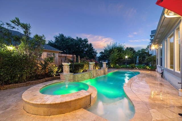 5214 Harvest Bend Ct, Sugar Land, TX 77479 - pool at dusk with a pool with connected hot tub, a fenced backyard, and a patio