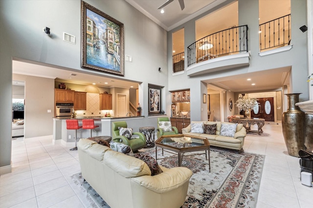 5214 Harvest Bend Ct, Sugar Land, TX 77479 - living room with light tile patterned floors, ornamental molding, a high ceiling, baseboards, and ceiling fan