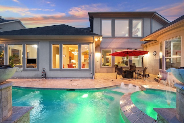 5214 Harvest Bend Ct, Sugar Land, TX 77479 - back of property featuring a patio, a pool with connected hot tub, a shingled roof, and stucco siding