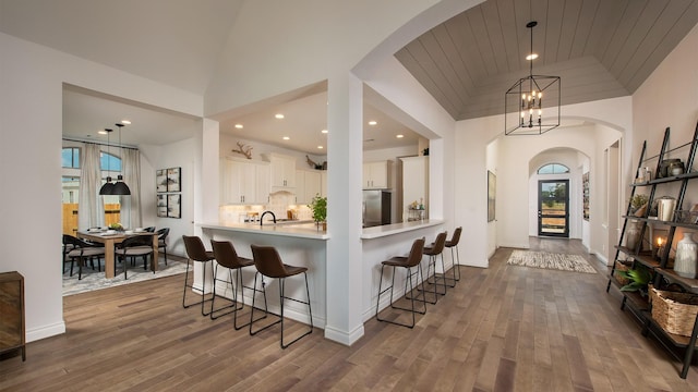 20315 Desert Foal Dr, Tomball, TX 77377 - foyer featuring arched walkways, dark wood-style flooring, a towering ceiling, recessed lighting, and baseboards