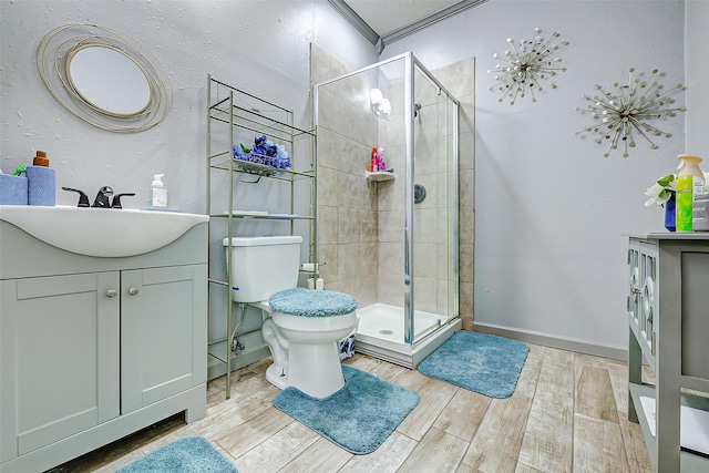 873 W Santa Fe St, Conroe, TX 77301 - full bath with vanity, a stall shower, toilet, wood finished floors, and ornamental molding