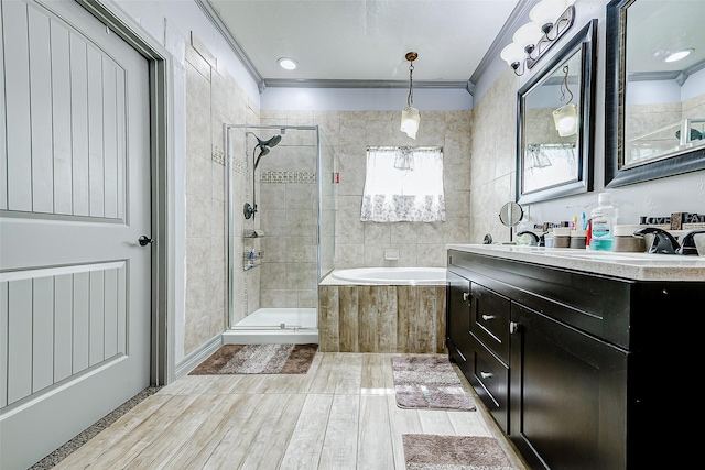 873 W Santa Fe St, Conroe, TX 77301 - full bath featuring ornamental molding, a shower stall, a bath, double vanity, and wood finished floors