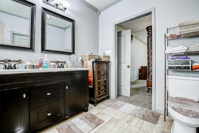 873 W Santa Fe St, Conroe, TX 77301 - bathroom with toilet, vanity, ornamental molding, and wood finished floors
