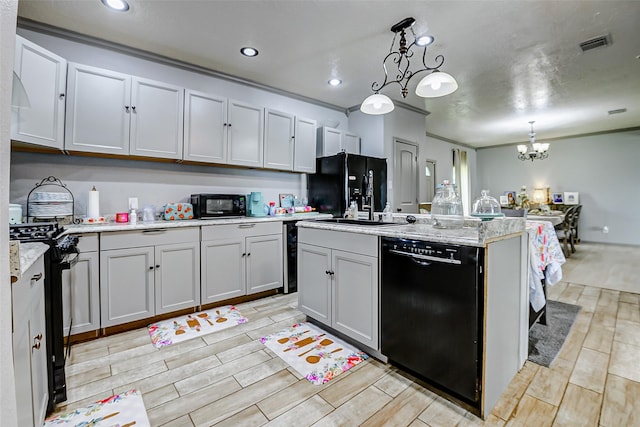 873 W Santa Fe St, Conroe, TX 77301 - kitchen with black appliances, a chandelier, wood tiled floors, a center island with sink, and recessed lighting