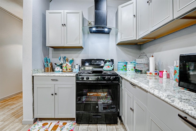 873 W Santa Fe St, Conroe, TX 77301 - kitchen featuring wall chimney range hood, black appliances, light wood finished floors, light stone counters, and white cabinetry