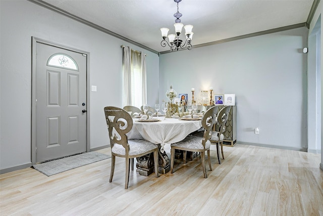 873 W Santa Fe St, Conroe, TX 77301 - dining room with a chandelier, light wood-style flooring, crown molding, and baseboards