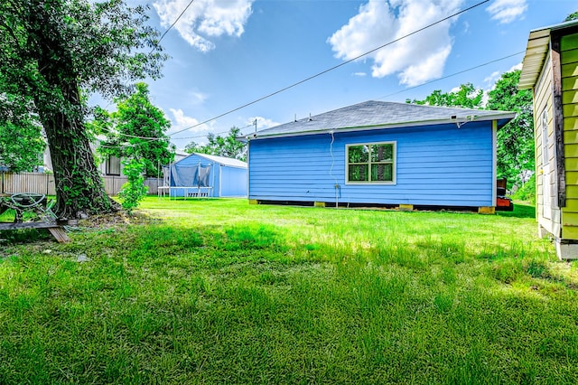 873 W Santa Fe St, Conroe, TX 77301 - rear view of property with a trampoline and roof with shingles