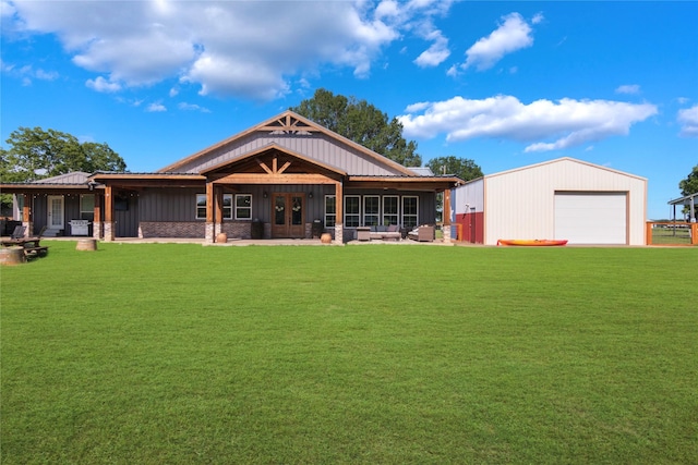 154 Lcr 893, Jewett, TX 75846 - rear view of house featuring a lawn, an outdoor structure, a detached garage, and french doors