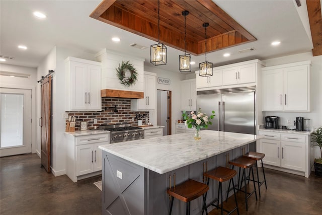 154 Lcr 893, Jewett, TX 75846 - kitchen with appliances with stainless steel finishes, concrete flooring, decorative backsplash, a center island, and light stone counters