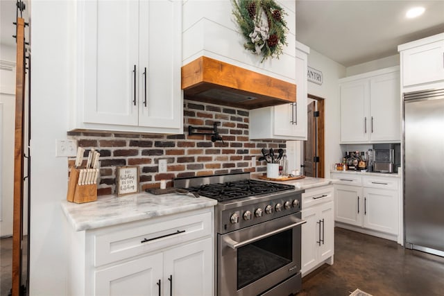 154 Lcr 893, Jewett, TX 75846 - kitchen with premium appliances, tasteful backsplash, custom exhaust hood, finished concrete flooring, and white cabinetry