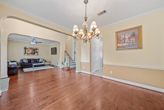 8910 Cote Ct, Houston, TX 77064 - living room with arched walkways, stairway, hardwood / wood-style flooring, a chandelier, and crown molding