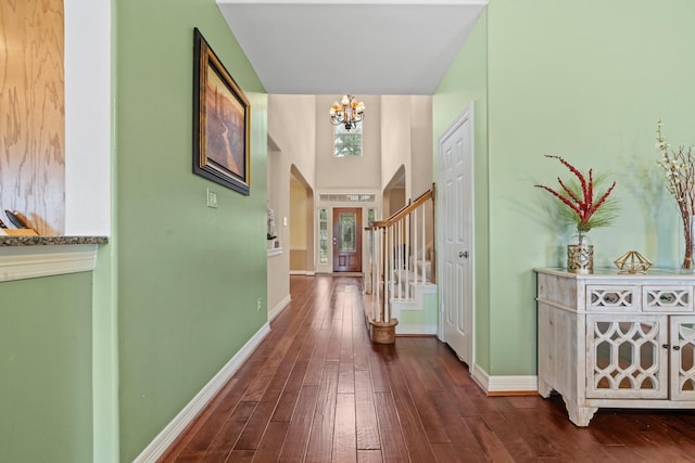 8910 Cote Ct, Houston, TX 77064 - entryway featuring a chandelier, dark wood-style floors, arched walkways, and baseboards