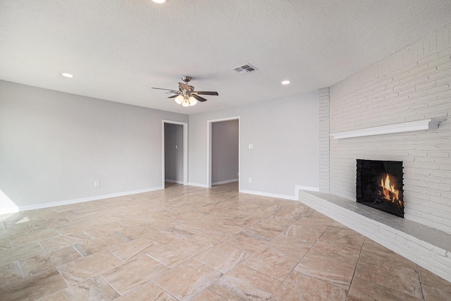 10056 Woodhollow Dr, Conroe, TX 77385 - unfurnished living room with a fireplace, a ceiling fan, a textured ceiling, baseboards, and recessed lighting