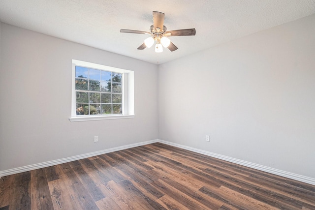 10056 Woodhollow Dr, Conroe, TX 77385 - empty room with dark wood finished floors, baseboards, ceiling fan, and a textured ceiling