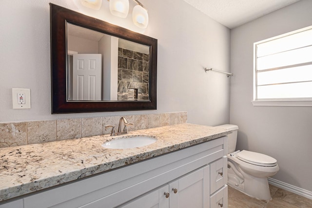 10056 Woodhollow Dr, Conroe, TX 77385 - bathroom featuring vanity, toilet, and baseboards
