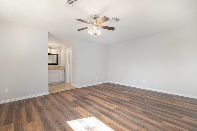 10056 Woodhollow Dr, Conroe, TX 77385 - unfurnished room with wood finished floors, a ceiling fan, and baseboards