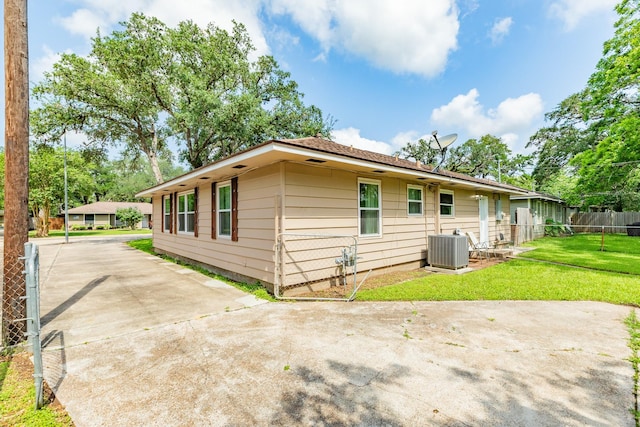 513 Gardenia St, Lake Jackson, TX 77566 - back of house with central AC, driveway, and a patio