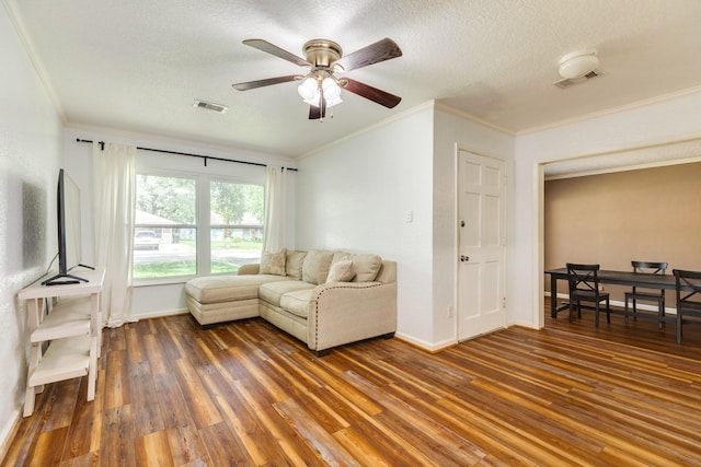 513 Gardenia St, Lake Jackson, TX 77566 - living room with ceiling fan, crown molding, wood finished floors, baseboards, and a textured ceiling