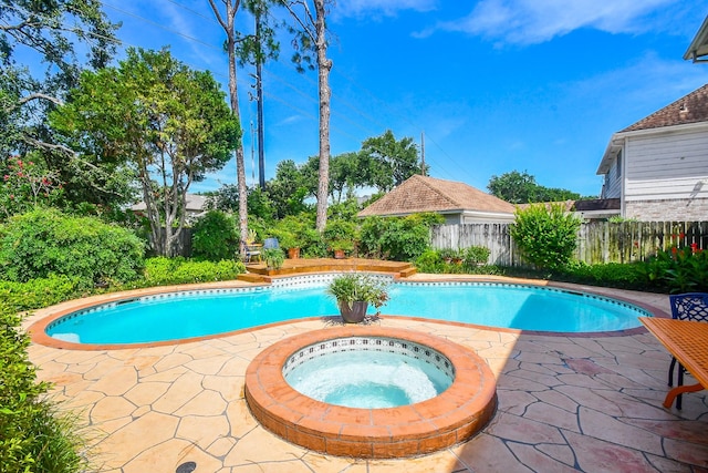 1023 Goldfinch Ave, Sugar Land, TX 77478 - view of pool with a patio, a fenced backyard, and an in-ground hot tub