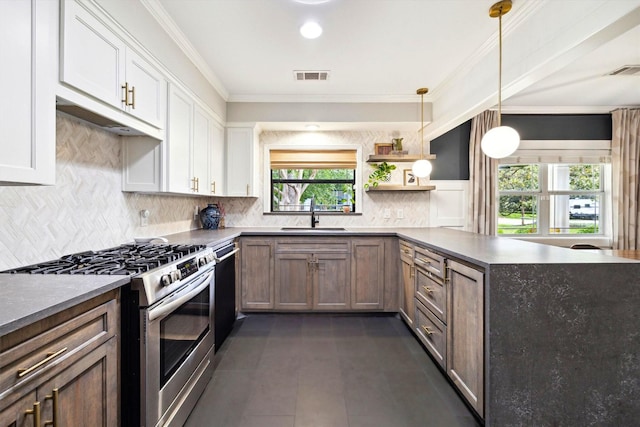 303 W 33rd St, Houston, TX 77018 - kitchen featuring stainless steel gas range oven, a sink, dishwashing machine, a peninsula, and decorative backsplash