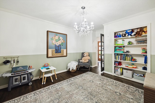 303 W 33rd St, Houston, TX 77018 - recreation room with crown molding, wood finished floors, a chandelier, and baseboards