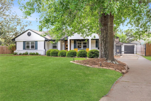 303 W 33rd St, Houston, TX 77018 - view of front of home with board and batten siding, driveway, and a gate