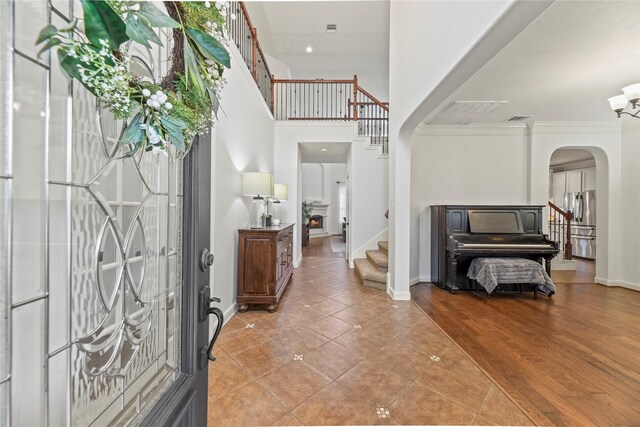 9210 Cold Hollow Ln, Missouri City, TX 77459 - entryway with arched walkways, stairway, baseboards, a towering ceiling, and light tile patterned floors