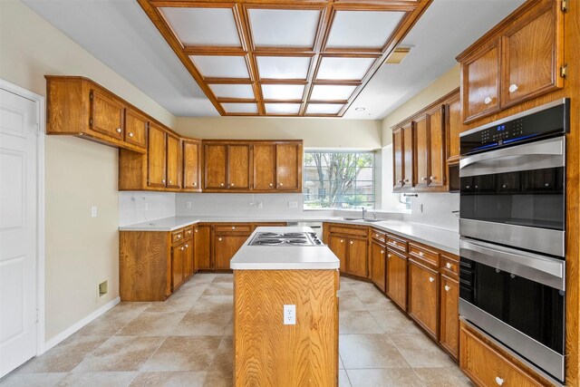 21735 Cayman Point Dr, Katy, TX 77450 - kitchen featuring brown cabinetry, a center island, and light countertops