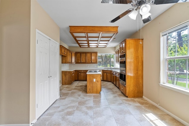 21735 Cayman Point Dr, Katy, TX 77450 - kitchen with brown cabinets, healthy amount of natural light, and a ceiling fan