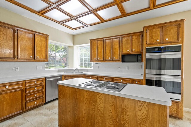21735 Cayman Point Dr, Katy, TX 77450 - kitchen with stainless steel appliances, brown cabinets, a sink, and light countertops
