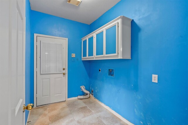 21735 Cayman Point Dr, Katy, TX 77450 - clothes washing area with washer hookup, electric dryer hookup, cabinet space, and baseboards