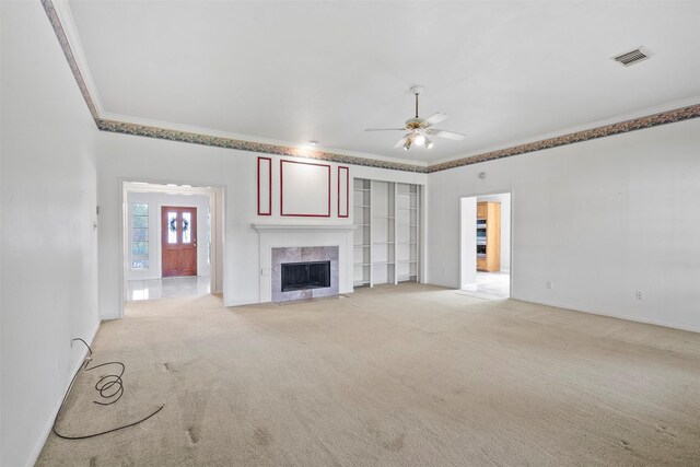 21735 Cayman Point Dr, Katy, TX 77450 - unfurnished living room featuring crown molding, a ceiling fan, a fireplace, light colored carpet, and baseboards
