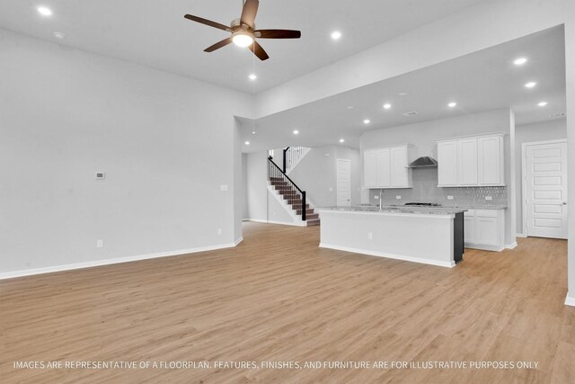 2808 Gran Castillo Dr, Texas City, TX 77568 - kitchen featuring open floor plan, recessed lighting, light wood-style floors, and white cabinets