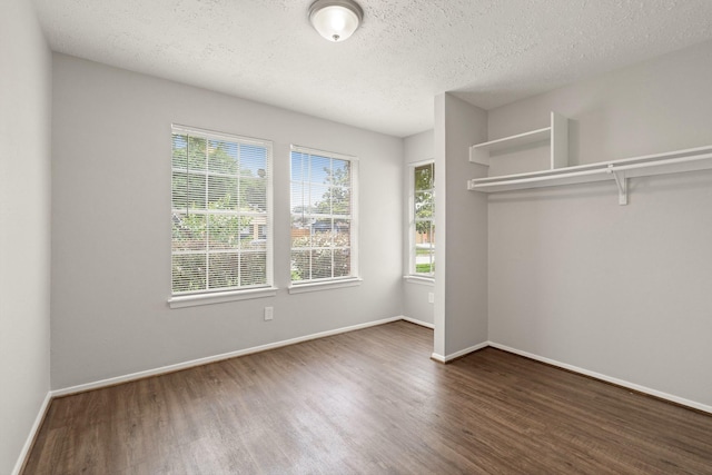 9219 Goodmeadow Dr, Houston, TX 77064 - unfurnished bedroom featuring wood finished floors, a textured ceiling, and baseboards