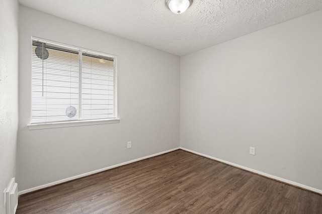 9219 Goodmeadow Dr, Houston, TX 77064 - unfurnished room with wood finished floors, baseboards, and a textured ceiling