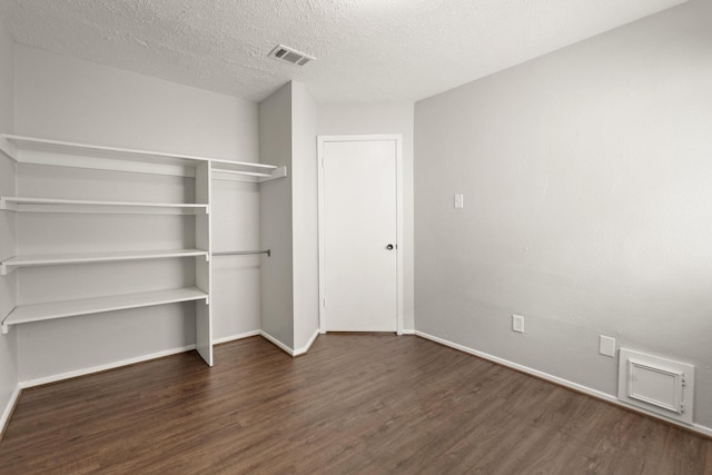 9219 Goodmeadow Dr, Houston, TX 77064 - unfurnished bedroom featuring wood finished floors, baseboards, a textured ceiling, and a closet