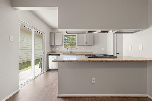 9219 Goodmeadow Dr, Houston, TX 77064 - kitchen featuring dishwashing machine, a sink, gray cabinets, light wood-type flooring, and cooktop