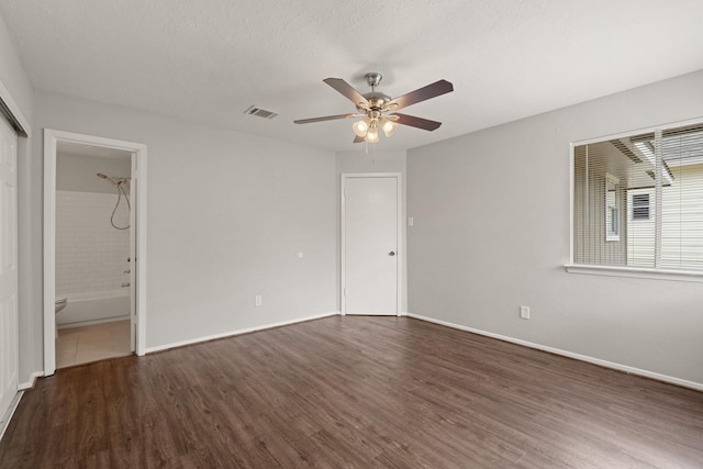 9219 Goodmeadow Dr, Houston, TX 77064 - unfurnished bedroom with wood finished floors, baseboards, connected bathroom, and a ceiling fan