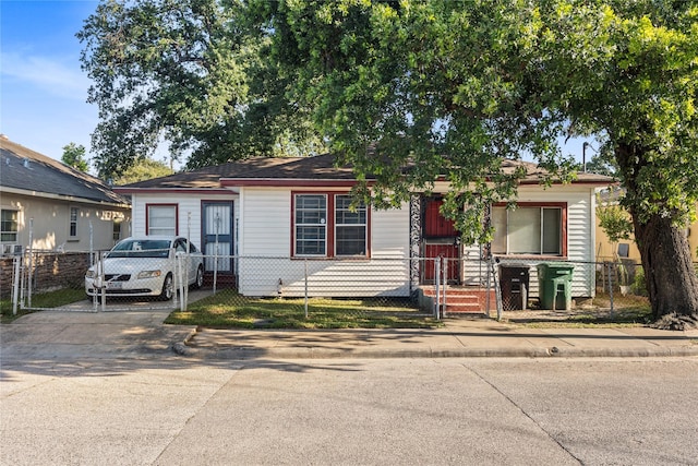 5410 Margarita St, Houston, TX 77020 - view of front of home featuring a fenced front yard, concrete driveway, and a gate