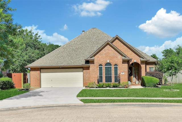 61 Chicory Ct, Lake Jackson, TX 77566 - view of front of property featuring brick siding, a garage, driveway, and roof with shingles