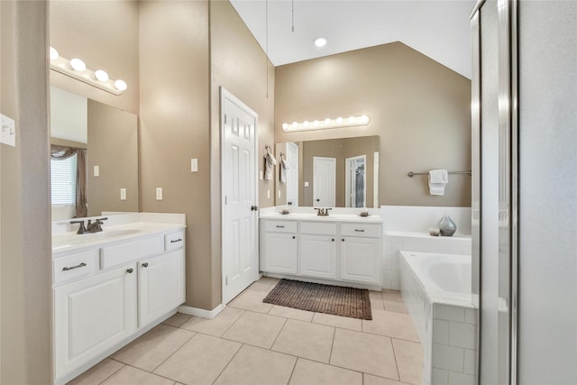 61 Chicory Ct, Lake Jackson, TX 77566 - full bathroom with tile patterned floors, two vanities, and a bath