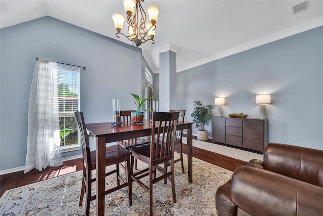 61 Chicory Ct, Lake Jackson, TX 77566 - dining space featuring dark wood-style flooring, a chandelier, baseboards, crown molding, and lofted ceiling