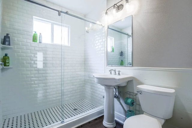 4434 Leeland St, Houston, TX 77023 - bathroom featuring a shower stall, toilet, and wood finished floors