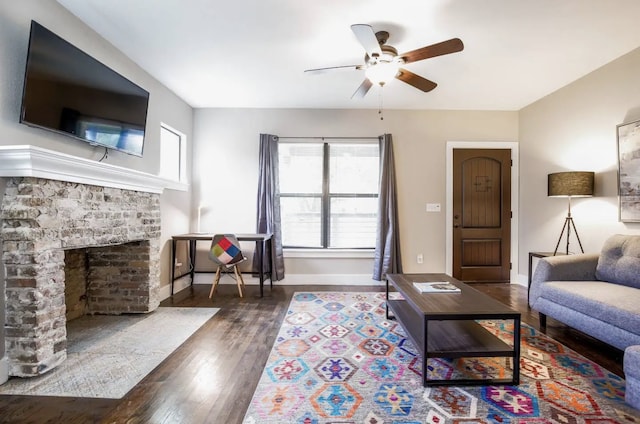 4434 Leeland St, Houston, TX 77023 - living room with a ceiling fan, wood finished floors, baseboards, and a brick fireplace