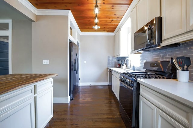 4434 Leeland St, Houston, TX 77023 - kitchen featuring black range with gas cooktop, stainless steel fridge with ice dispenser, crown molding, baseboards, and tasteful backsplash